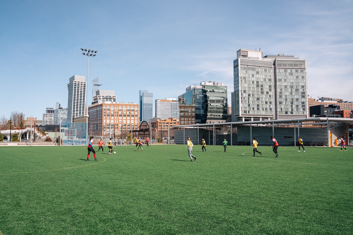 Players on the Gansevoort Peninsula turf field