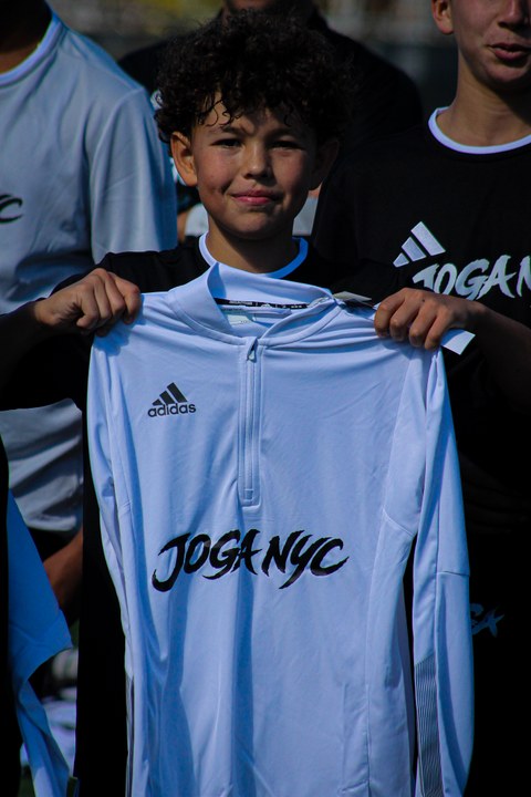 A player holding a JOGA NYC jersey at The Showcase, photographed by Ethan Amaya