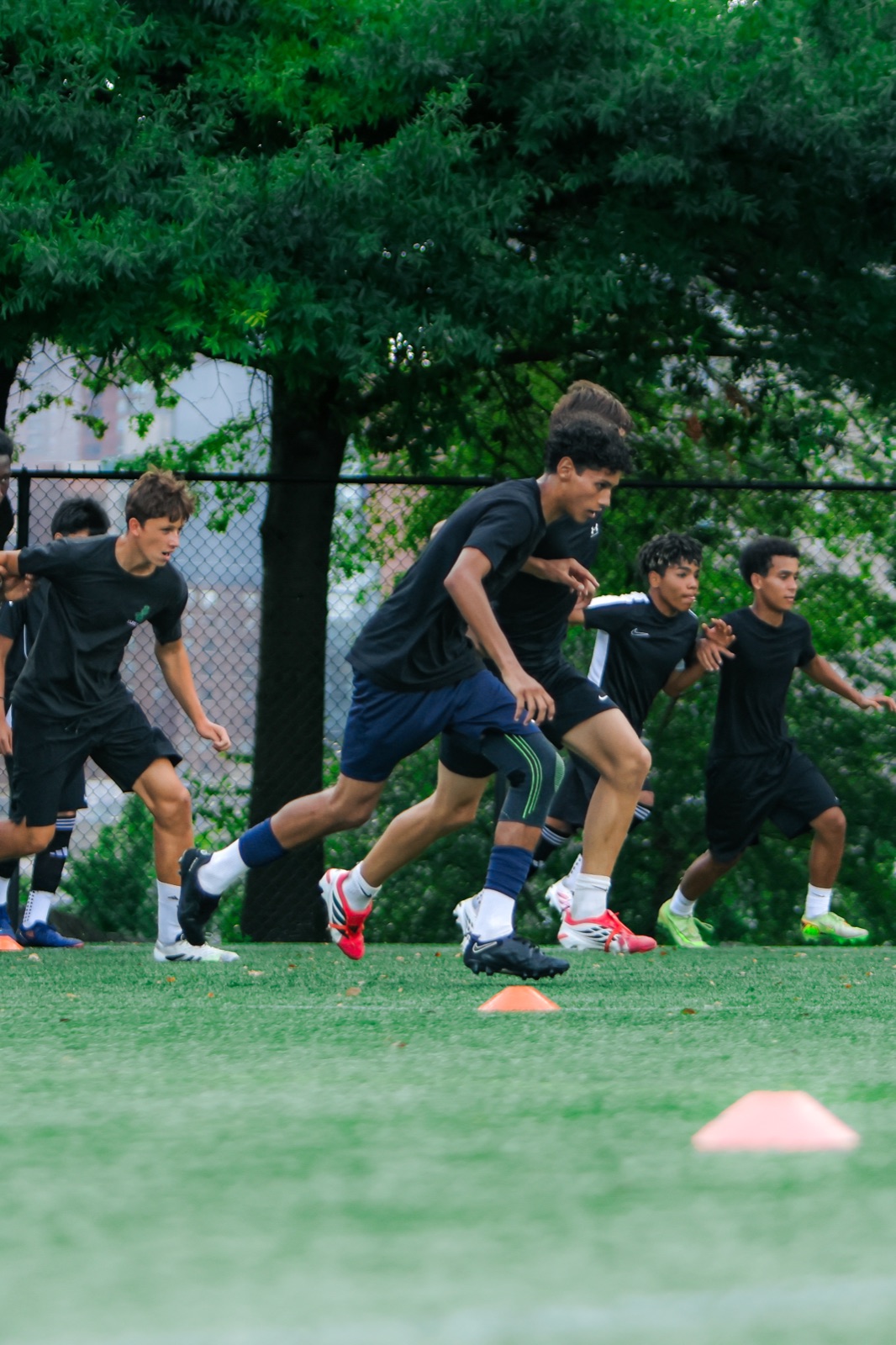 Players accelerating through cones during an athletic training drill
